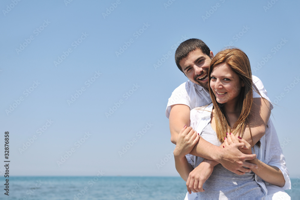 happy young couple have fun on beach happy young couple have fun on beach