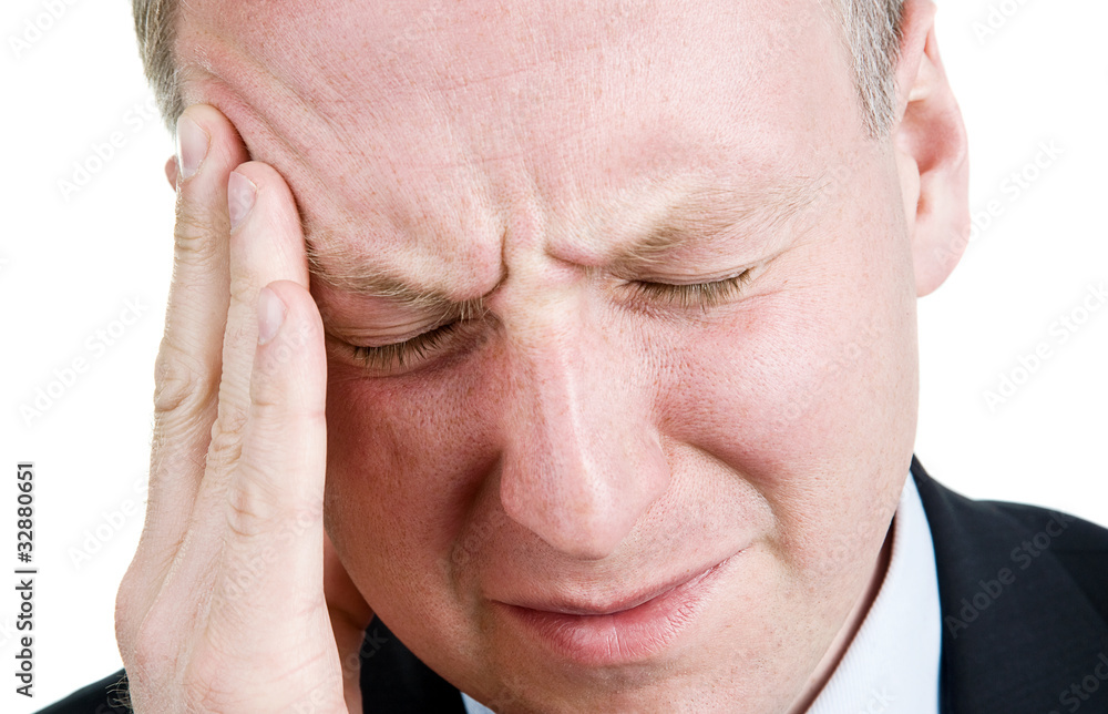 Mid aged man suffering from headache Mid aged man suffering from headache