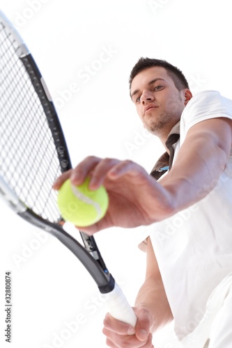 Young tennis player serving © nyul