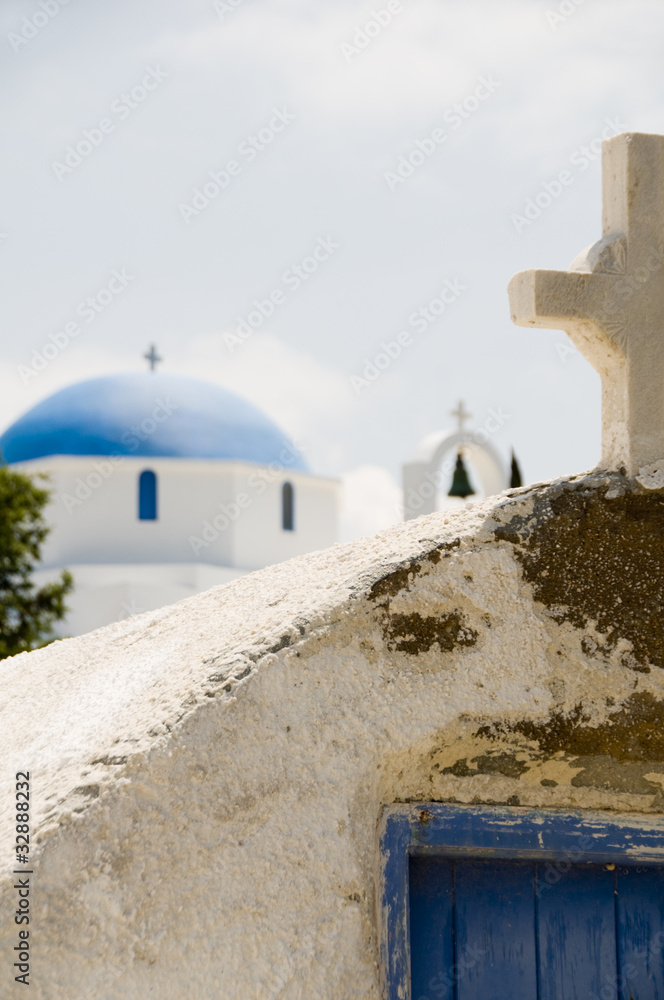 ancient Greek Island church with cross blue dome church backgrou