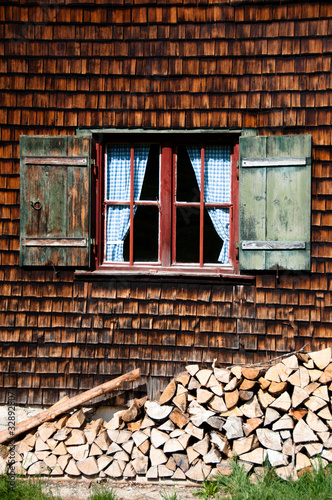 Ancient window on log house wooden wall