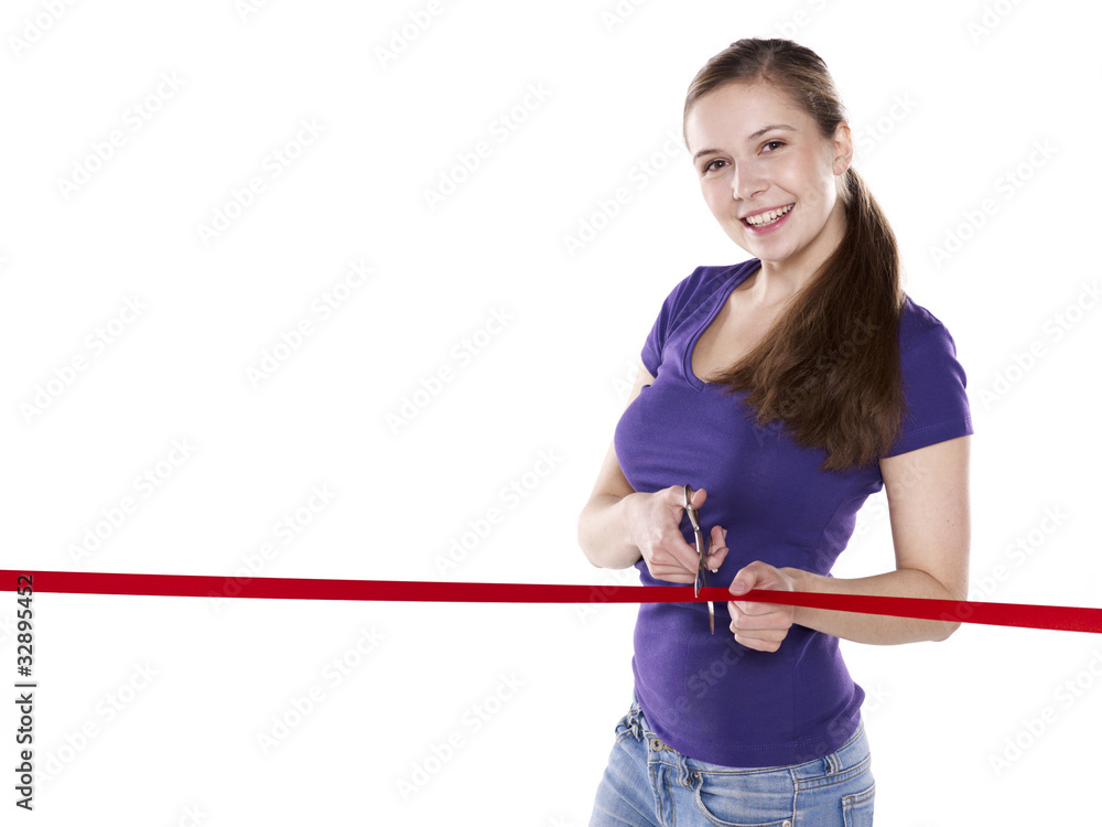 young woman is cutting red ribbon for opening young woman is cutting red ribbon for opening
