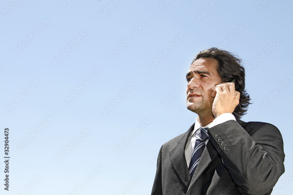 Young happy businessman calling on mobile phone, outdoor Young happy businessman calling on mobile phone, outdoor