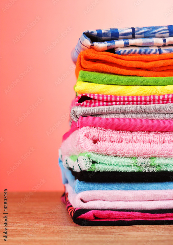 Pile of colorful clothes over red background Pile of colorful clothes over red background
