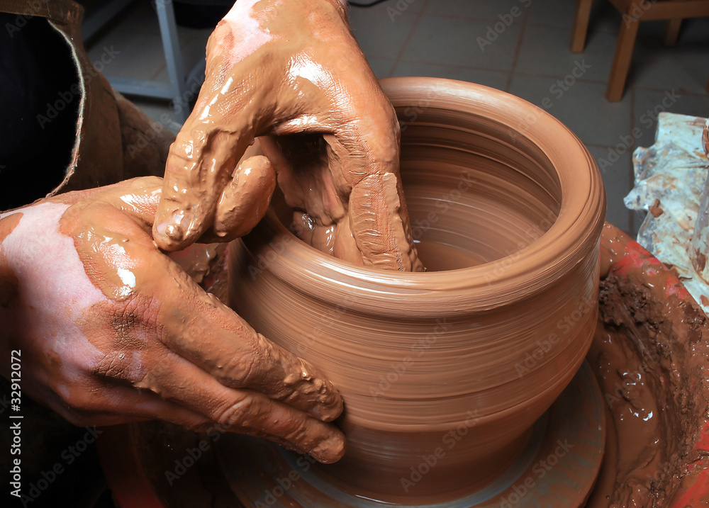 hands of a potter, creating an earthen jar on the circle hands of a potter, creating an earthen jar on the circle