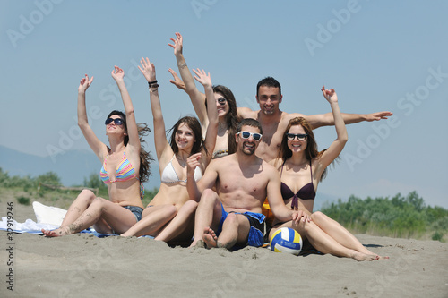 Group of happy young people in have fun at beach