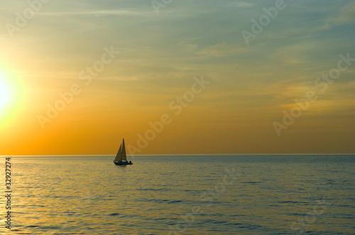 Yacht sailing on the sea, to meet the sunset