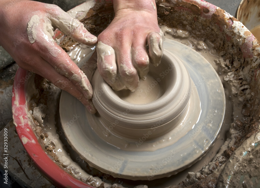 hands of a potter, creating an earthen jar on the circle hands of a potter, creating an earthen jar on the circle