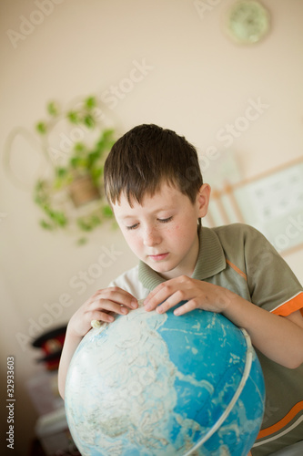 boy studying Globe