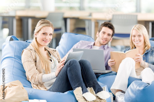 Group of high-school students with books sitting