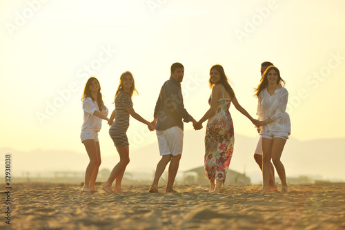 happy young  people group have fun on beach
