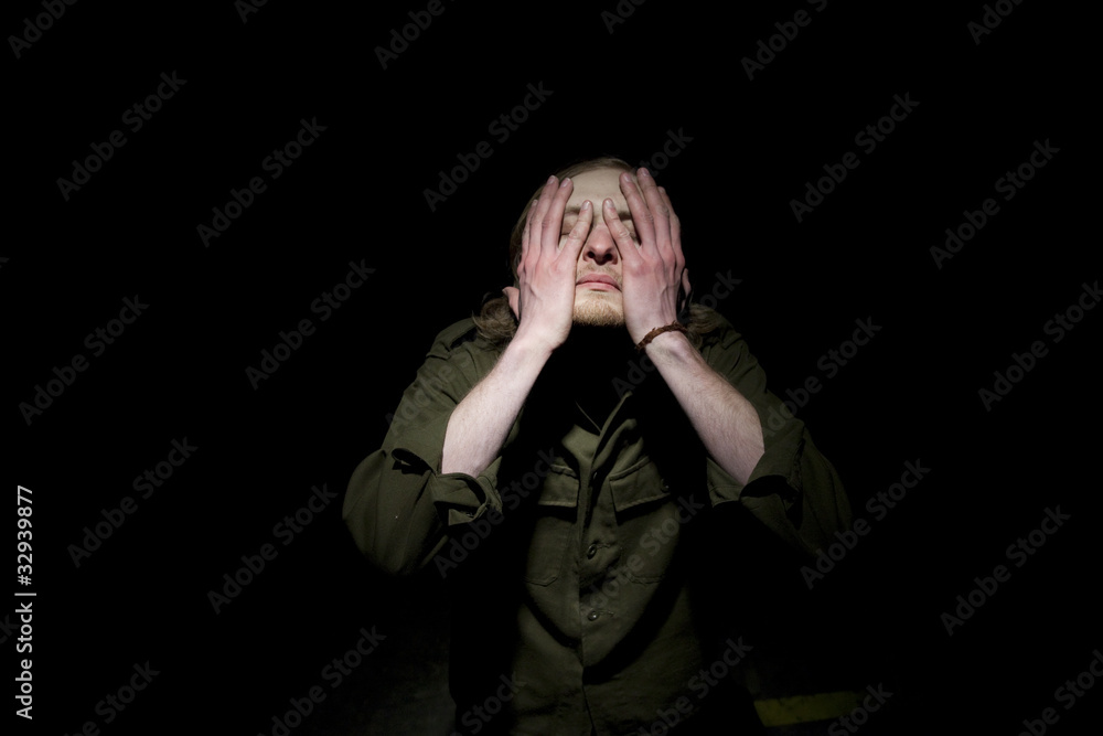 Man hiding his eyes Man hiding his eyes