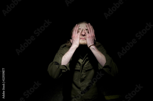 Man hiding his eyes