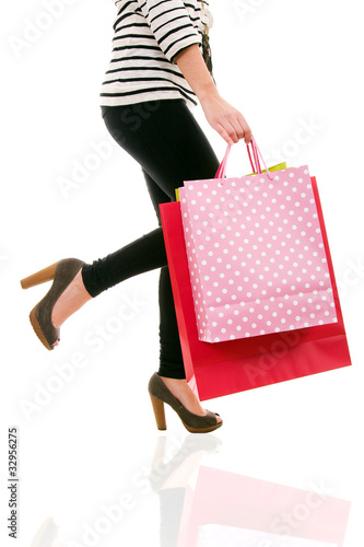 waist-down view of woman carrying shopping bags