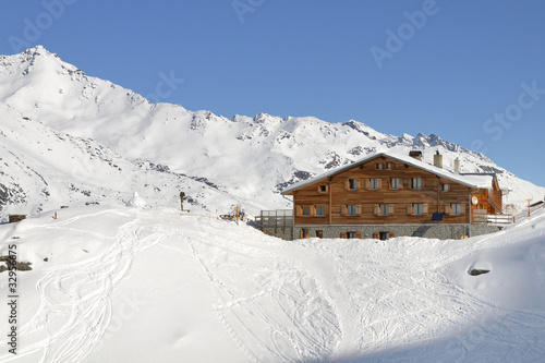 Winter landscape in high Val Martello with mountain refuge