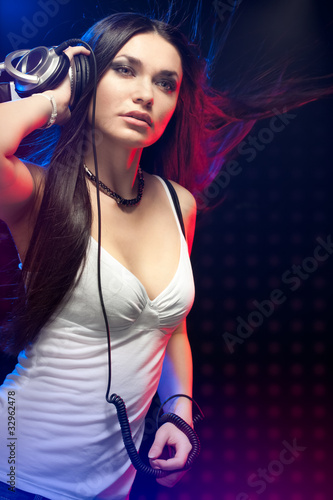 beautiful woman dj wearing headphones