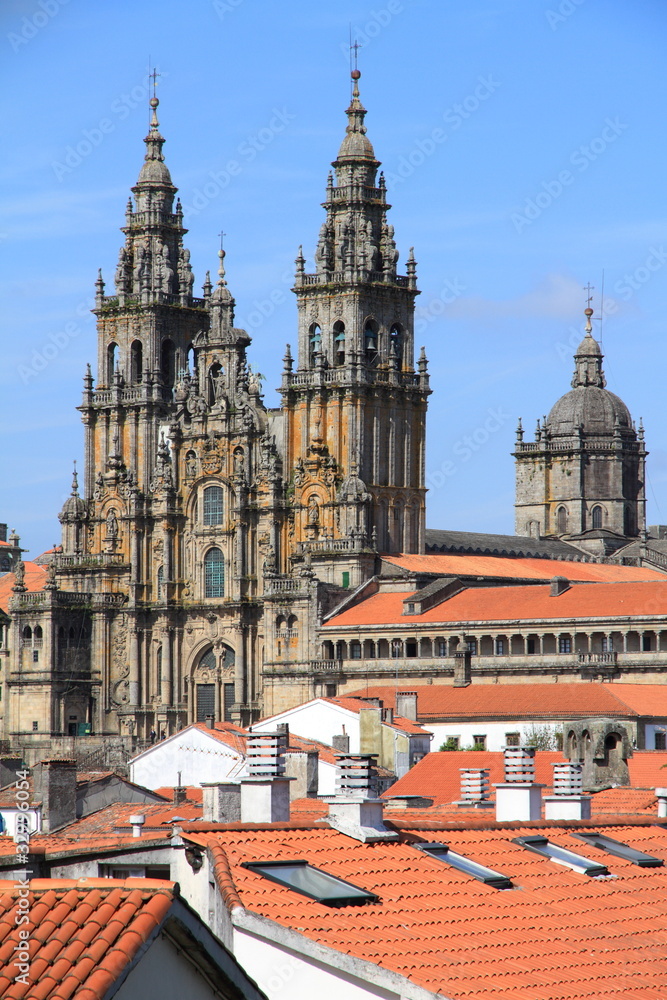 Fototapeta premium Cathedral of Santiago de Compostela over roofs with blue sky