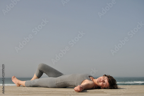 Young sporty girl relaxing exercise on the beach
