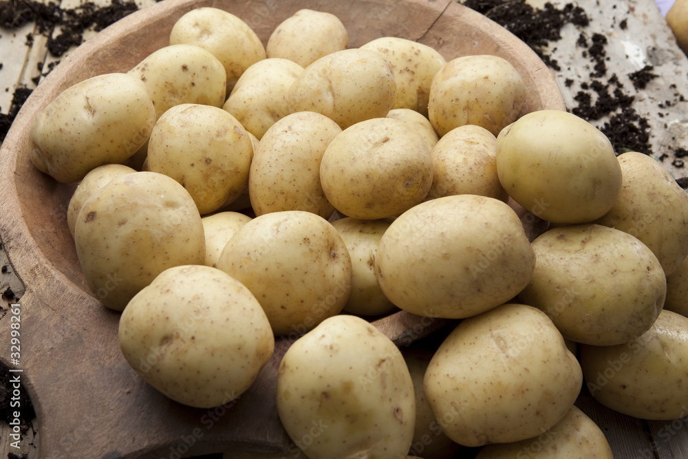 Loose potatoes in a rustic wooden bowl Loose potatoes in a rustic wooden bowl