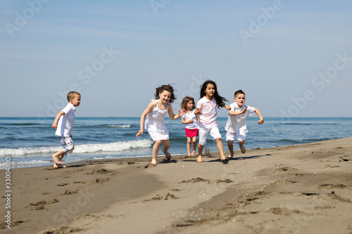 happy child group playing  on beach