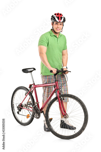Smiling man posing with a mountain bike
