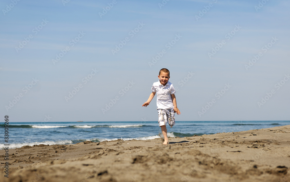 little boy running on beach