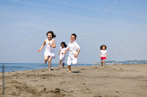happy child group playing on beach