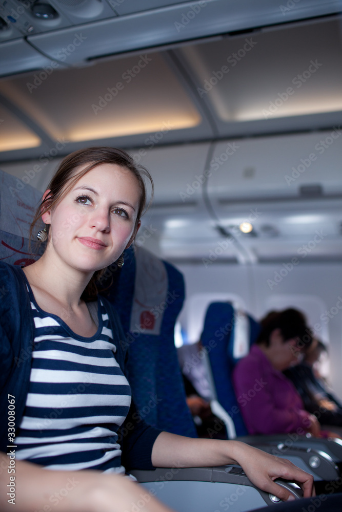 young female passenger on board of an aircraft young female passenger on board of an aircraft