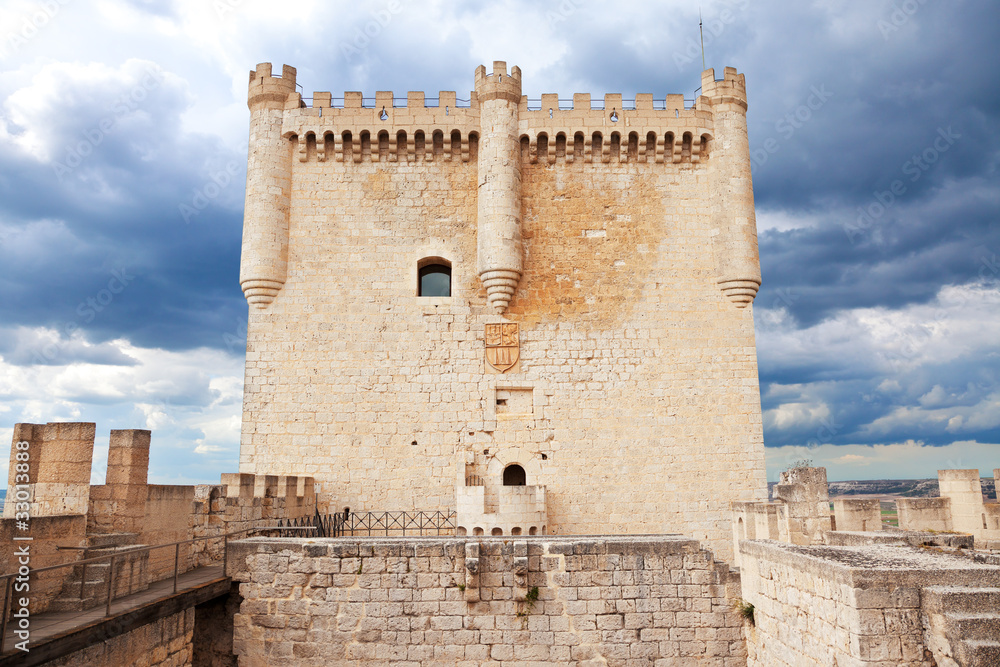 Main tower of Peñafiel castle against a stormy sky, Spain