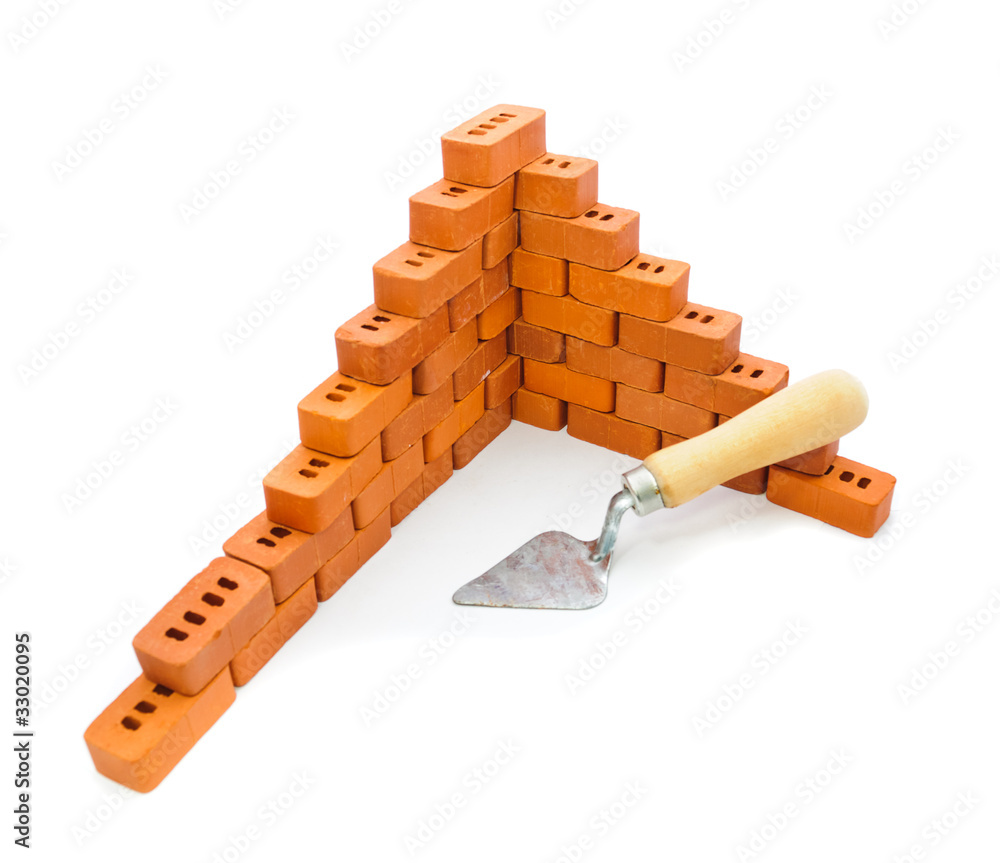 Small trowel and bricks for construction Small trowel and bricks for construction