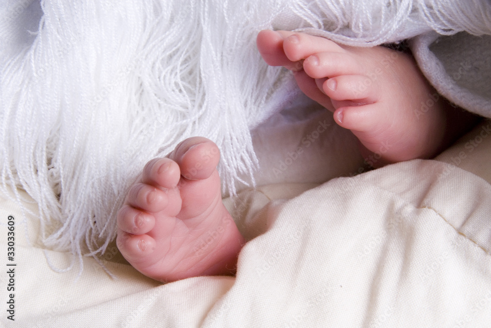Tiny Feet of Newborn Baby in a White Blanket Tiny Feet of Newborn Baby in a White Blanket