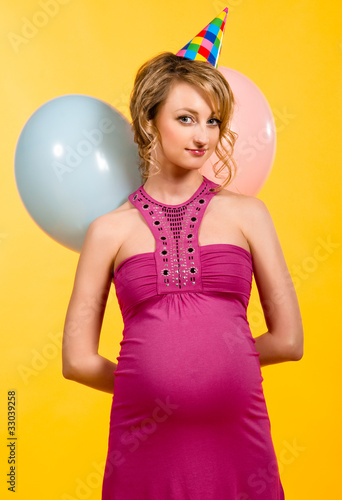 Lovely pregnant young woman with balloons