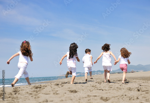 happy child group playing on beach