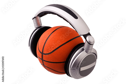Headphones on a basketball ball, sport and music concept
