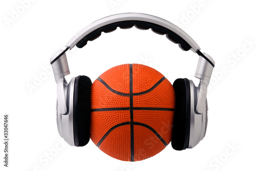 Headphones on a basketball ball, sport and music concept