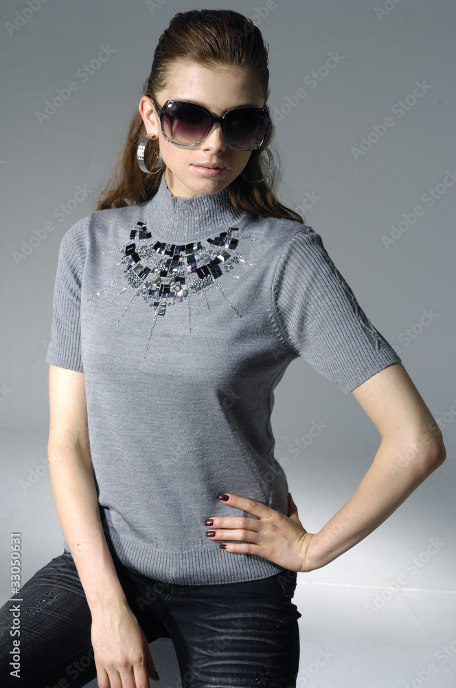 Beautiful casual young woman wearing modern sunglasses Beautiful casual young woman wearing modern sunglasses
