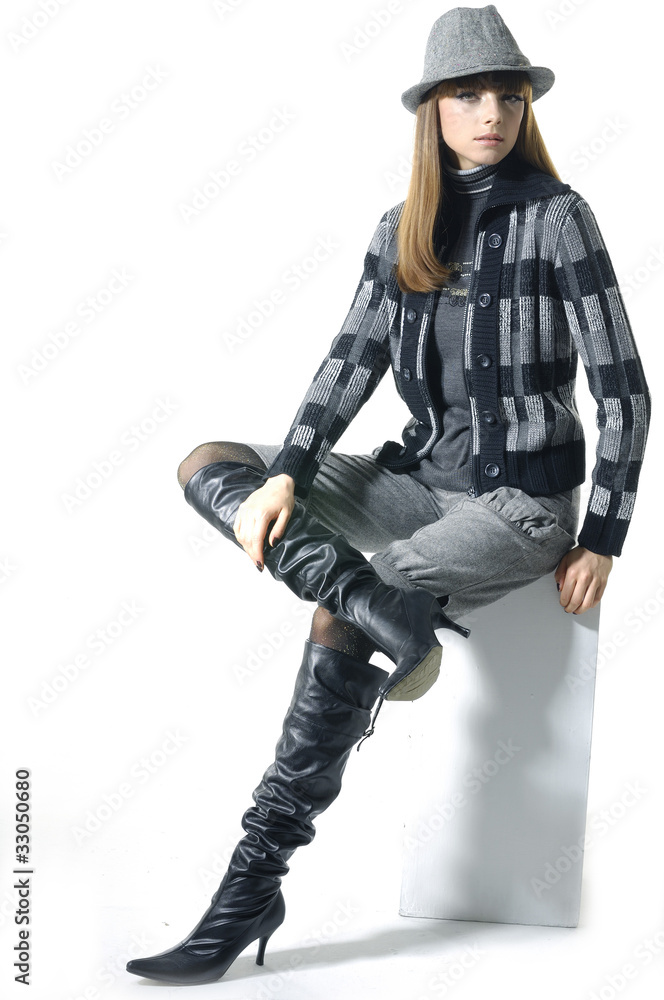 Attractive young fashion model in hat posing in the studio Attractive young fashion model in hat posing in the studio