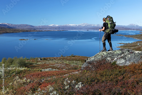 long distance Hiker over a lake in the north of sweden