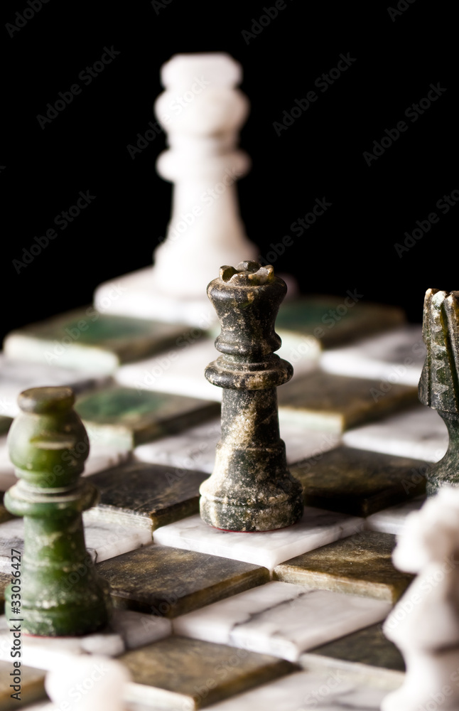 Marble chessboard formation on a black background Stock Photo | Adobe Stock