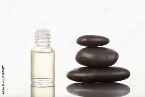 Black pebbles stack and a glass phial
