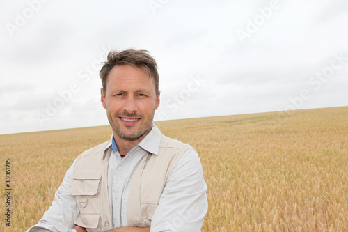 Portrait of handsome man standing in wheat field