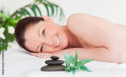 Happy young woman lying on her belly