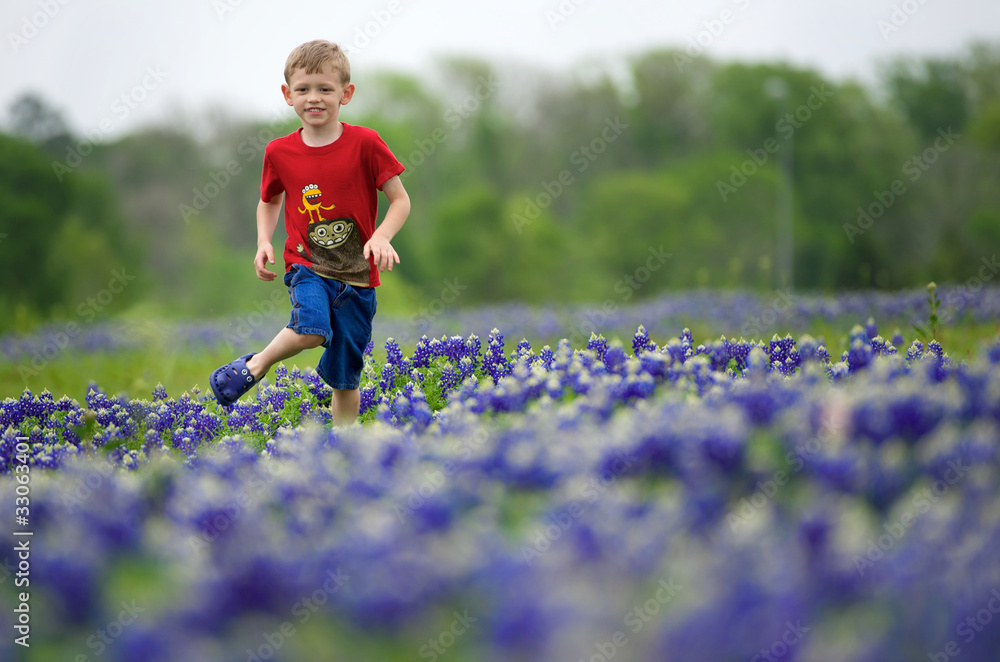 Boy running through a Bluebonnet field Boy running through a Bluebonnet field