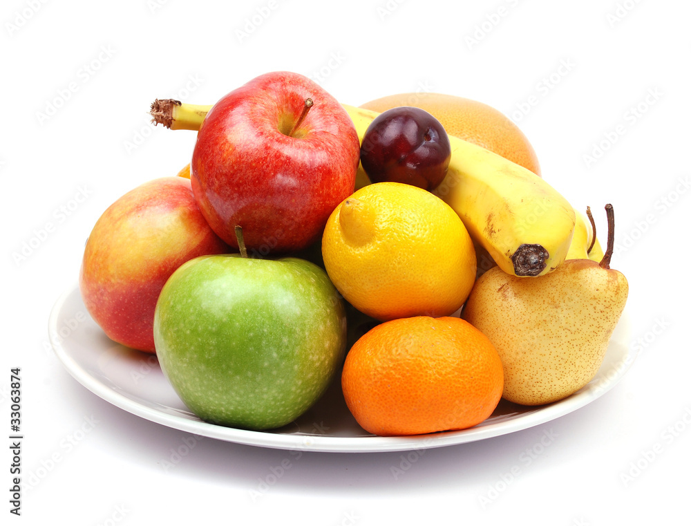 fruit plate with citrus fruits, apples, banana, plum