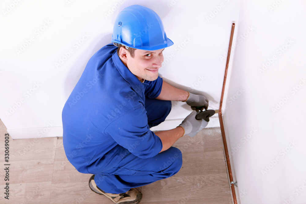 Plumber installing pipes Plumber installing pipes