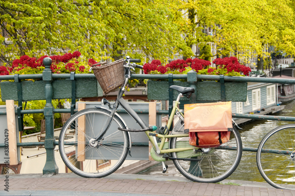 Naklejka premium Bike parked on a bridge in Amsterdam, Netherlands