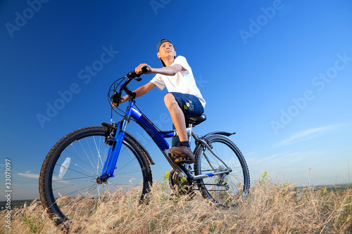 Fototapeta Naklejka Na Ścianę i Meble -  The boy with a bicycle