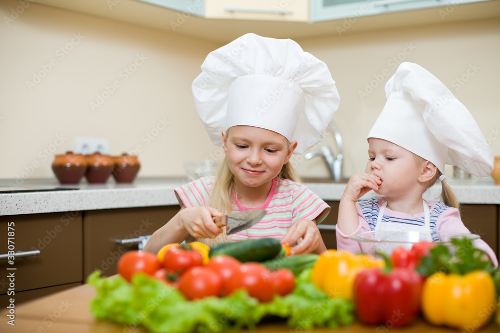 two little girls preparing healthy food on kitchen two little girls preparing healthy food on kitchen