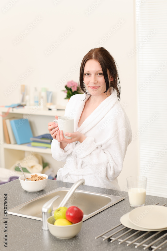Young student girl have breakfast in kitchen