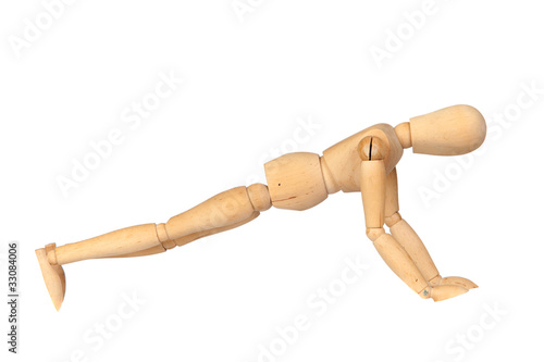 Jointed wooden mannequin doing push-ups photo